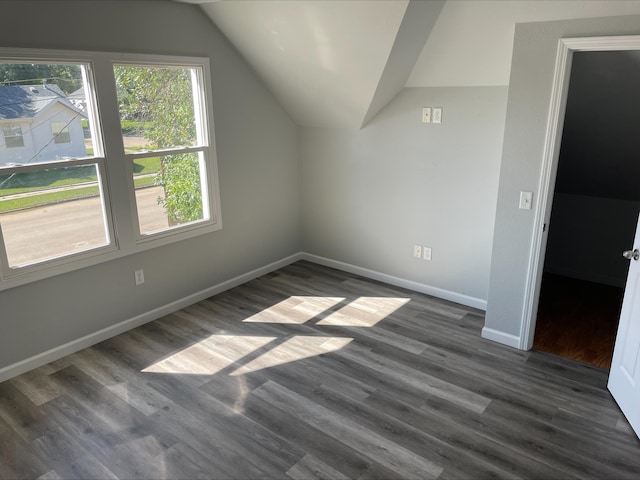 bonus room with lofted ceiling and dark hardwood / wood-style flooring