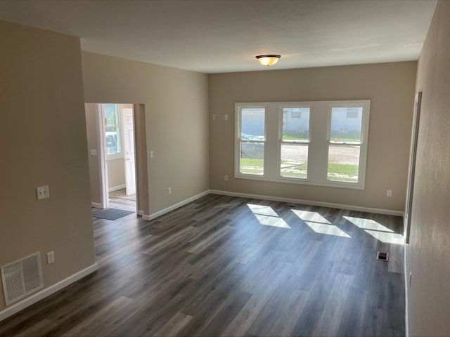 unfurnished room with dark hardwood / wood-style floors