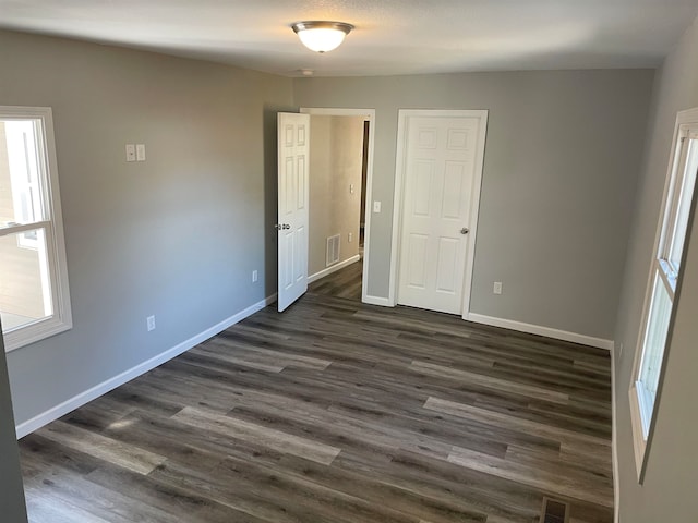 empty room with dark hardwood / wood-style floors