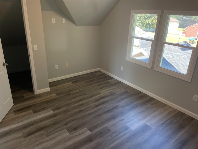 additional living space with lofted ceiling and dark hardwood / wood-style floors