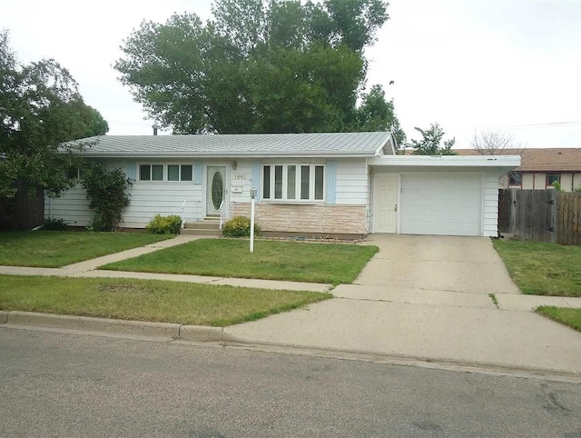 ranch-style home featuring a garage and a front lawn