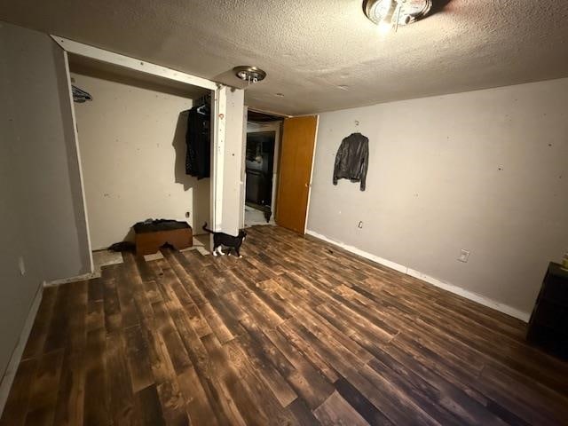 interior space with dark hardwood / wood-style flooring and a textured ceiling