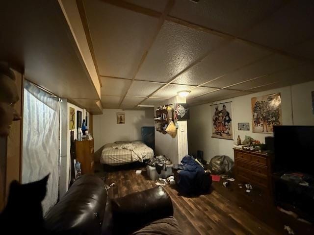 bedroom featuring a paneled ceiling and wood-type flooring