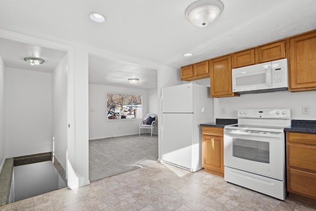 kitchen with white appliances and light colored carpet