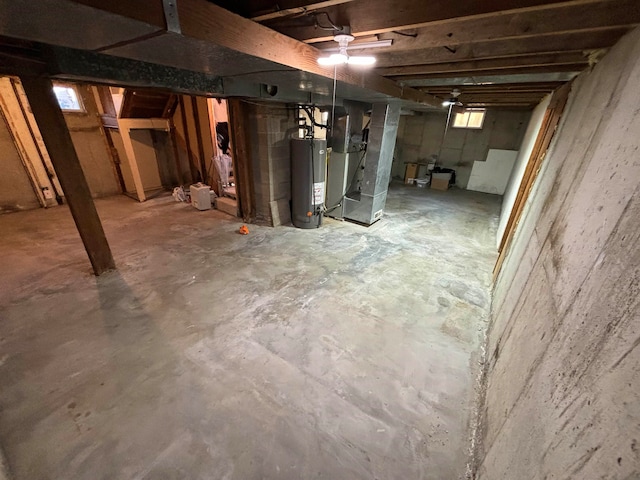 basement featuring heating unit and water heater