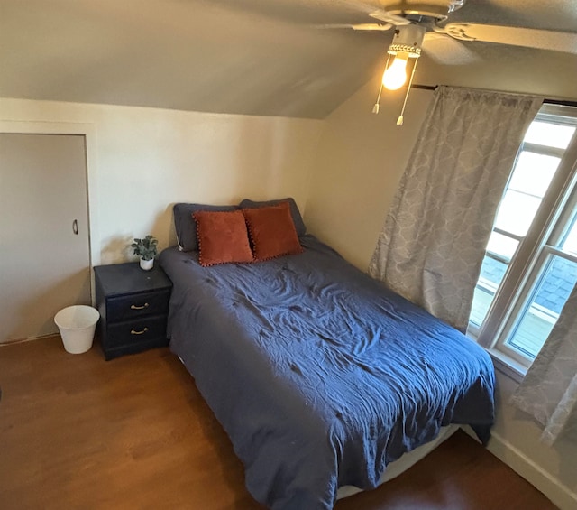 bedroom featuring lofted ceiling, ceiling fan, and wood finished floors