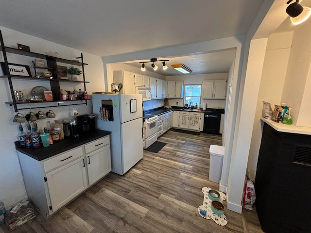 kitchen with dark wood-style floors, white appliances, dark countertops, and white cabinets