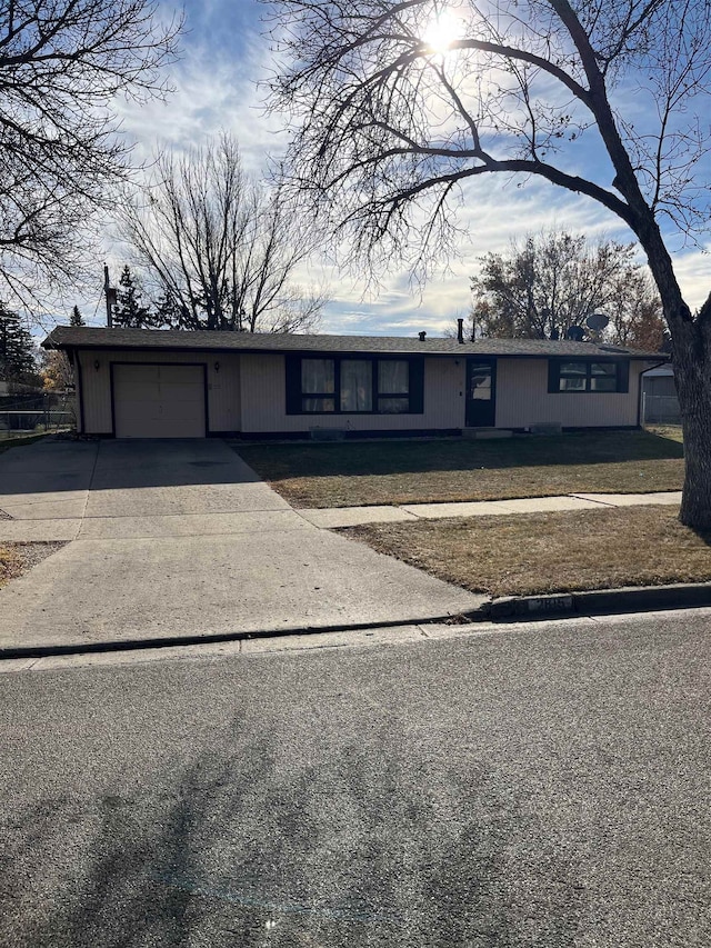 view of front of property featuring a garage and a front lawn