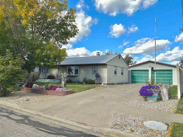 view of front of property with a garage and an outbuilding