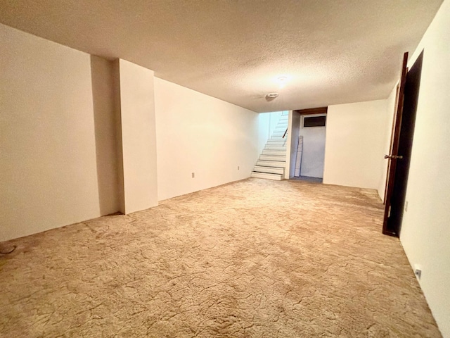 empty room featuring carpet flooring and a textured ceiling