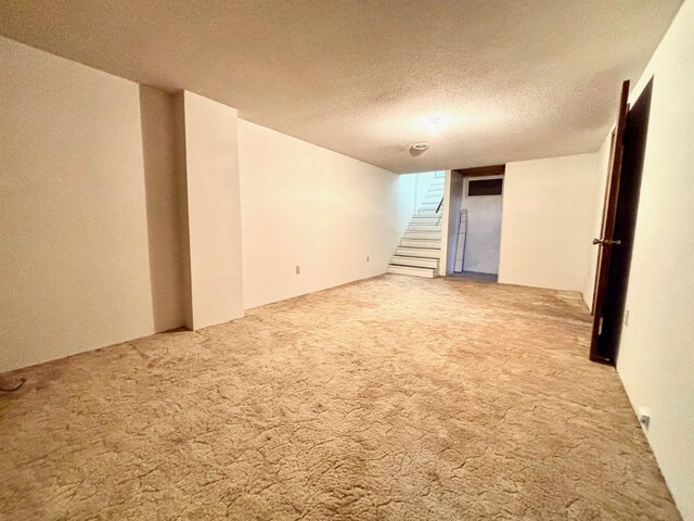 6 4th Ave, Towner, ND 58788 - carpeted spare room with stairway and a textured ceiling