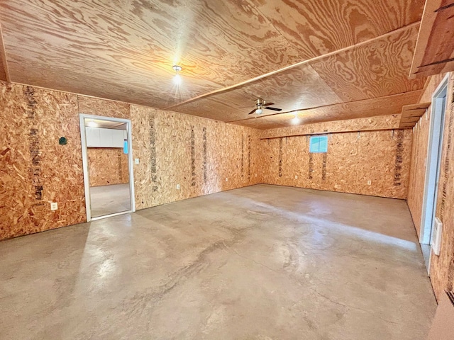 bonus room with concrete flooring and ceiling fan