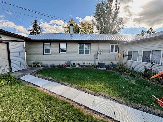 6 4th Ave, Towner, ND 58788 - view of front facade featuring a front lawn, metal roof, and a chimney