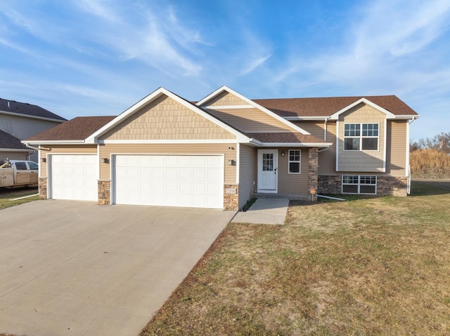 view of front of property with a garage and a front lawn