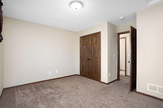 unfurnished bedroom featuring a closet and carpet floors