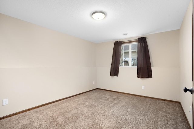 spare room featuring a textured ceiling and carpet floors