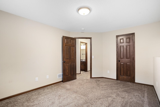 unfurnished bedroom with light colored carpet