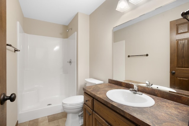 bathroom featuring walk in shower, vanity, and toilet