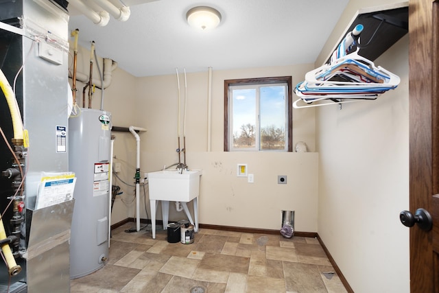 laundry area featuring water heater, heating unit, and electric dryer hookup