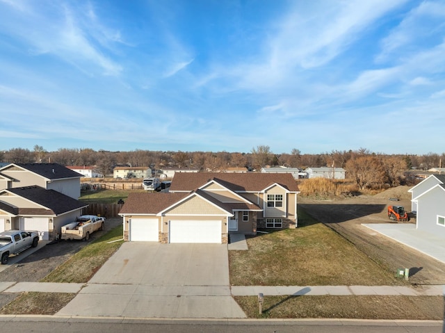 view of front of property with a garage and a front lawn