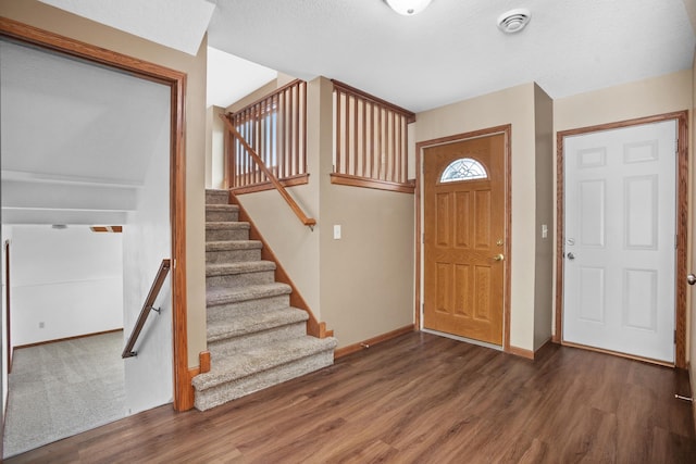 entryway featuring a textured ceiling and dark hardwood / wood-style floors