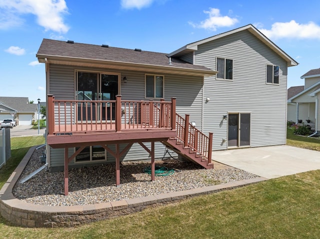 back of house featuring a yard, a patio, and a wooden deck