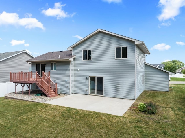 back of house with a yard, a patio, and a wooden deck