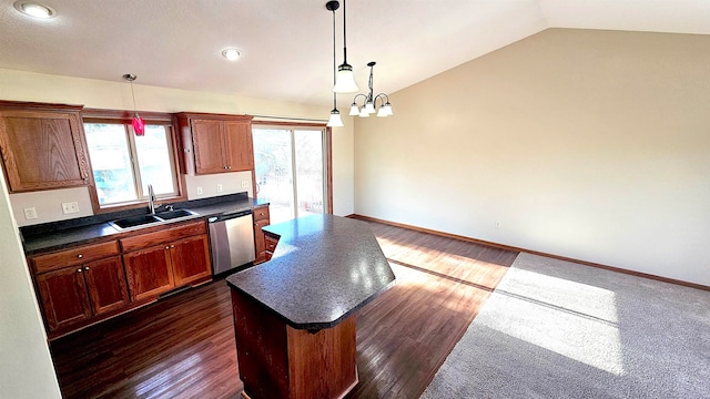 kitchen with stainless steel dishwasher, sink, a center island, hanging light fixtures, and lofted ceiling