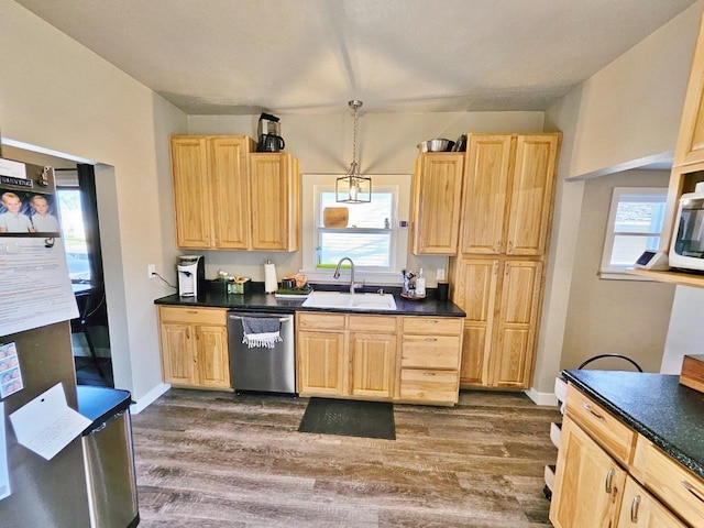 kitchen with sink, light brown cabinets, hanging light fixtures, stainless steel dishwasher, and dark hardwood / wood-style floors