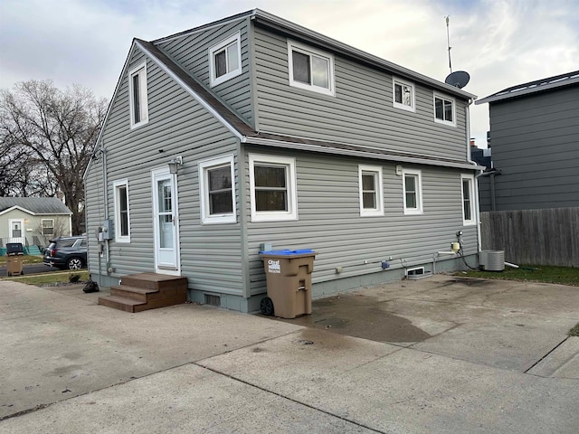 back of property featuring central AC and a patio