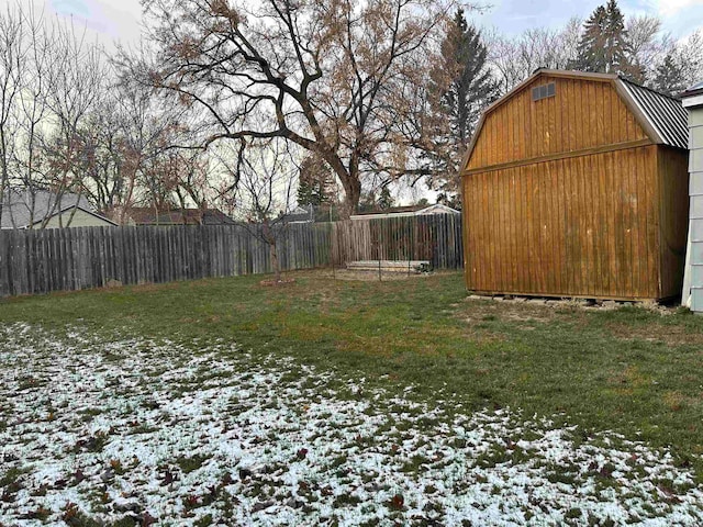 yard layered in snow with a storage unit