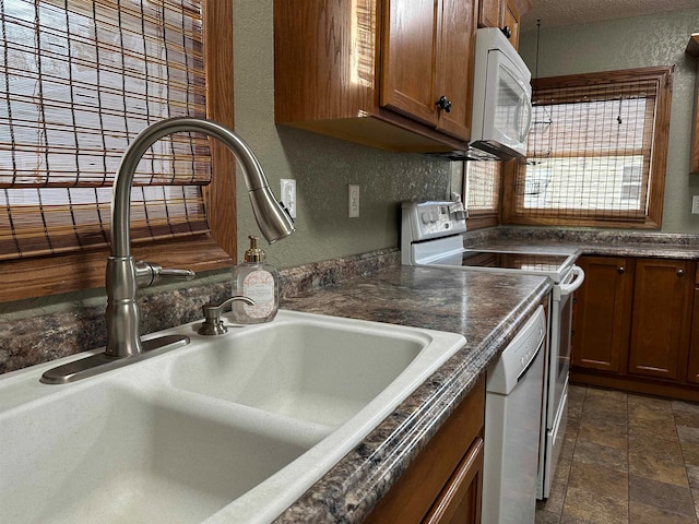 kitchen featuring white appliances and sink