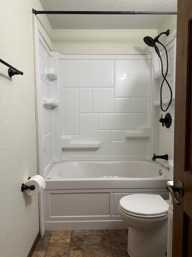 bathroom with shower / bathing tub combination, toilet, and a textured ceiling