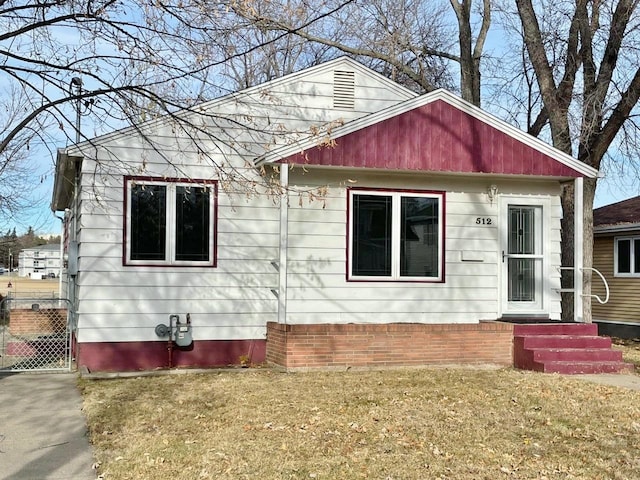 bungalow-style home with a front lawn