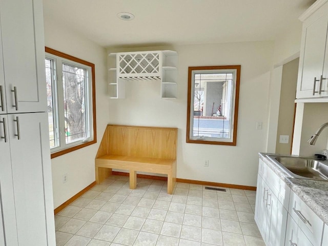 interior space featuring light tile patterned floors and sink