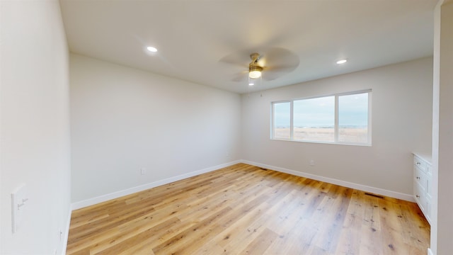 empty room featuring light hardwood / wood-style flooring and ceiling fan