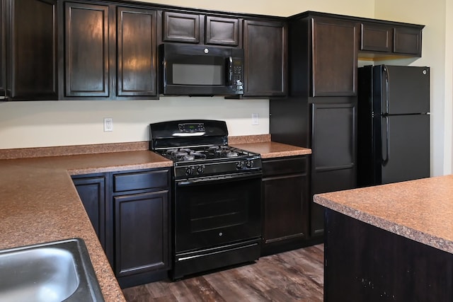 kitchen with black appliances, dark brown cabinets, sink, and dark wood-type flooring