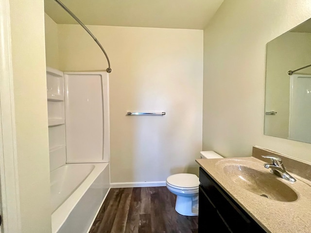 full bathroom featuring washtub / shower combination, toilet, wood-type flooring, and vanity