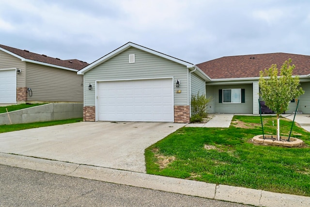 ranch-style home featuring a front yard and a garage