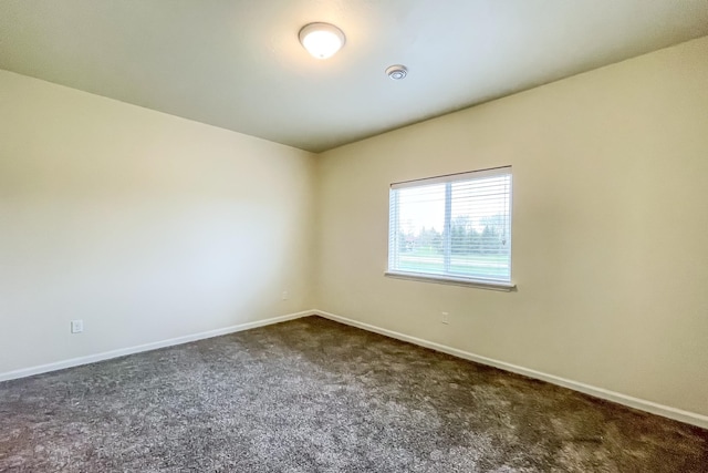 empty room featuring dark carpet