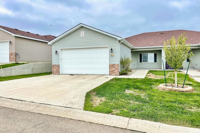 single story home featuring a garage and a front yard