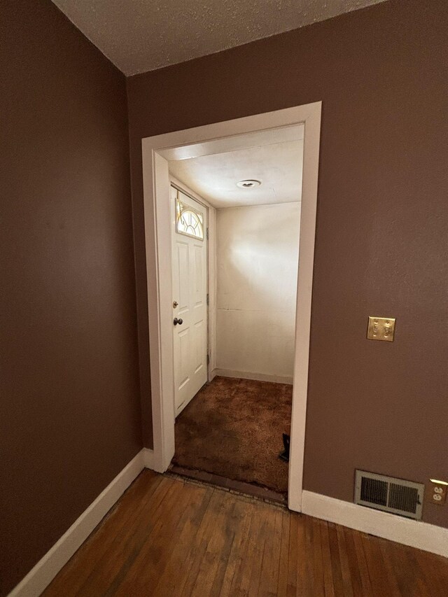 1107 SE 2nd St, Minot, ND 58701 - corridor featuring baseboards and hardwood / wood-style flooring