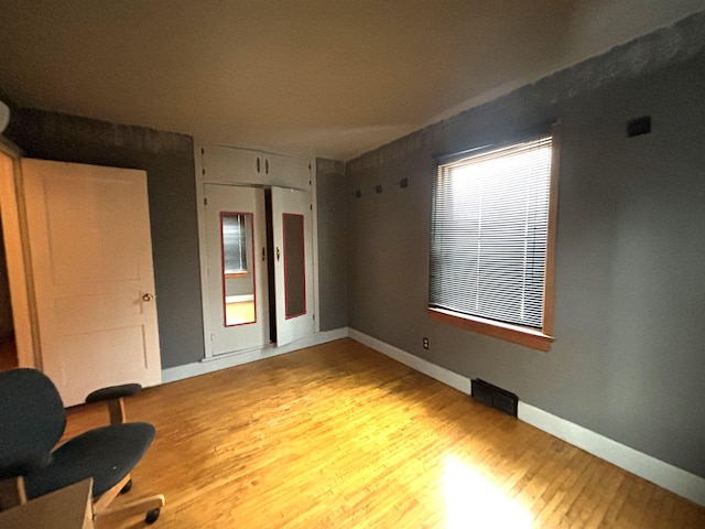 1107 SE 2nd St, Minot, ND 58701 - bedroom with wood finished floors, baseboards, and a closet