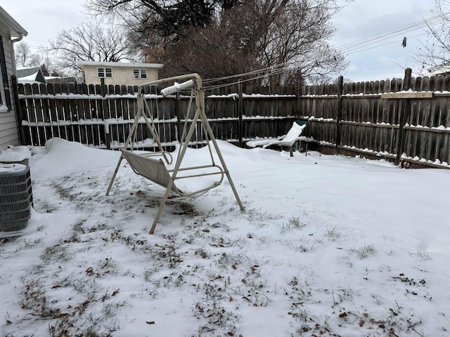 1107 SE 2nd St, Minot, ND 58701 - yard covered in snow featuring a fenced backyard and central AC