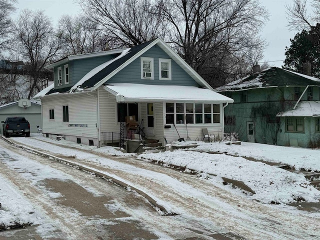 view of front of property with a garage and an outdoor structure