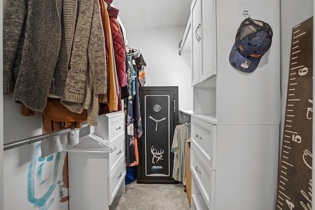 walk in closet featuring light colored carpet