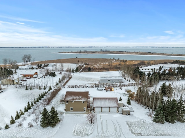 snowy aerial view featuring a water view