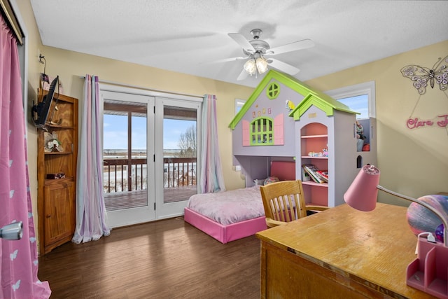 bedroom with ceiling fan, dark hardwood / wood-style flooring, a textured ceiling, and access to outside