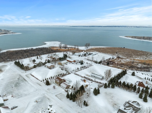 snowy aerial view featuring a water view