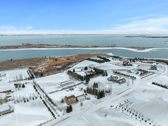 snowy aerial view with a water view